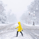 A person crosses the street during a snowstorm on January 3, 2022 in Washington, DC.